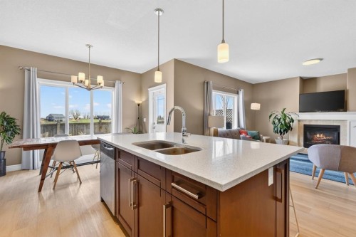 1612 Monteith Drive Se, High River, AB - Indoor Photo Showing Kitchen With Fireplace With Double Sink