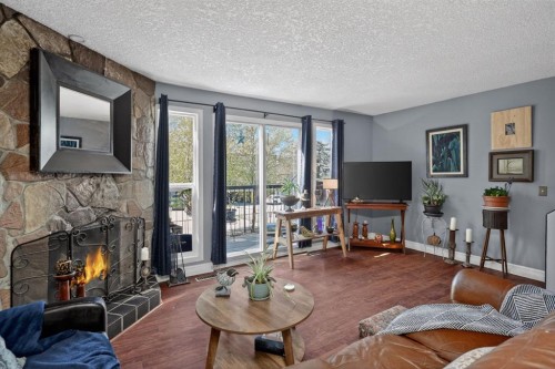 23-643 4 Avenue Ne, Calgary, AB - Indoor Photo Showing Living Room With Fireplace