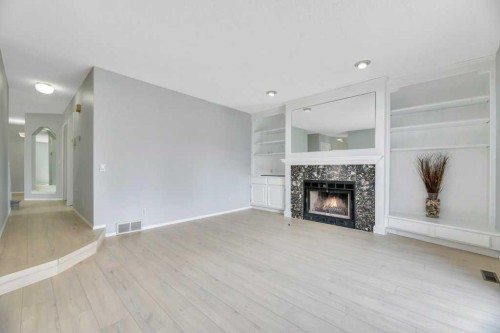 215 Hawktree Circle Nw, Calgary, AB - Indoor Photo Showing Living Room With Fireplace