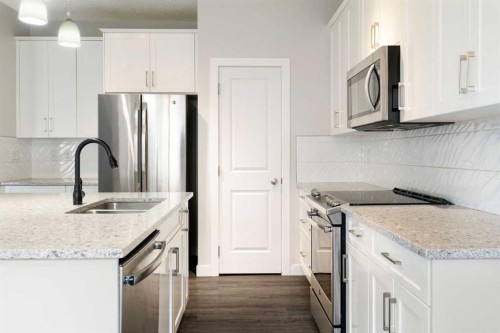 239 Kinniburgh Road, Chestermere, AB - Indoor Photo Showing Kitchen With Stainless Steel Kitchen With Double Sink With Upgraded Kitchen