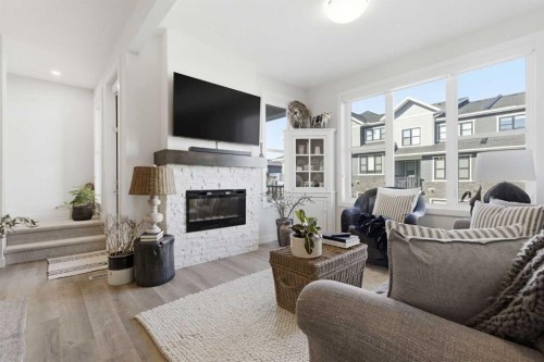 307 Crestridge Common Sw, Calgary, AB - Indoor Photo Showing Living Room With Fireplace