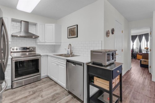 1114-1818 Simcoe Boulevard Sw, Calgary, AB - Indoor Photo Showing Kitchen With Stainless Steel Kitchen With Double Sink