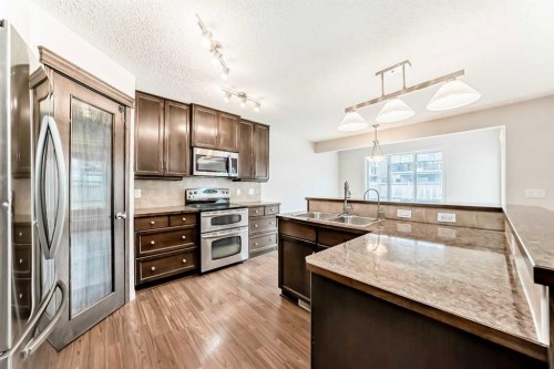 455 Cimarron Boulevard, Okotoks, AB - Indoor Photo Showing Kitchen With Double Sink With Upgraded Kitchen