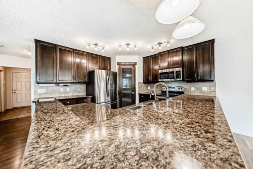 455 Cimarron Boulevard, Okotoks, AB - Indoor Photo Showing Kitchen With Double Sink