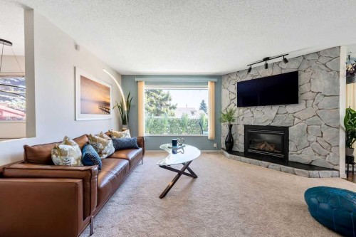 59 Strathcona Close Sw, Calgary, AB - Indoor Photo Showing Living Room With Fireplace