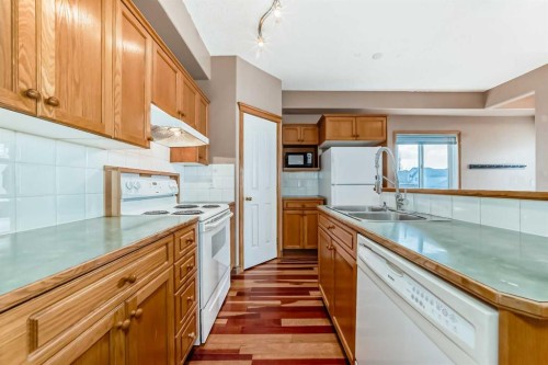 89 Hidden Ranch Hill Nw, Calgary, AB - Indoor Photo Showing Kitchen With Double Sink