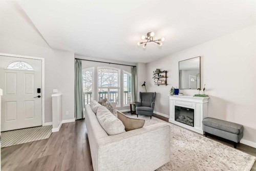 136 Hidden Hills Road Nw, Calgary, AB - Indoor Photo Showing Living Room With Fireplace