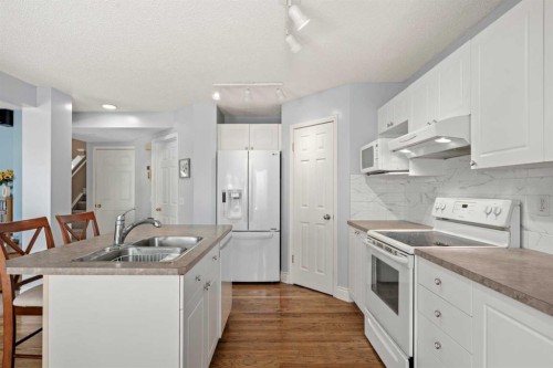 66 Crystalridge Crescent, Okotoks, AB - Indoor Photo Showing Kitchen With Double Sink