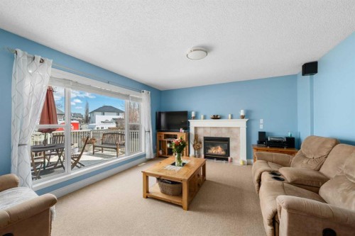 66 Crystalridge Crescent, Okotoks, AB - Indoor Photo Showing Living Room With Fireplace