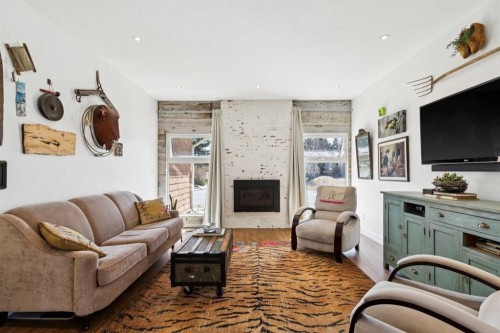 104 Cedarpark Drive Sw, Calgary, AB - Indoor Photo Showing Living Room With Fireplace