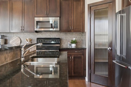 161 Heritage Bay, Cochrane, AB - Indoor Photo Showing Kitchen With Double Sink With Upgraded Kitchen