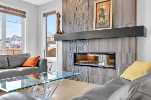 192 Magnolia Manor Se, Calgary, AB - Indoor Photo Showing Living Room With Fireplace