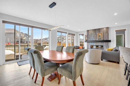 192 Magnolia Manor Se, Calgary, AB - Indoor Photo Showing Dining Room With Fireplace