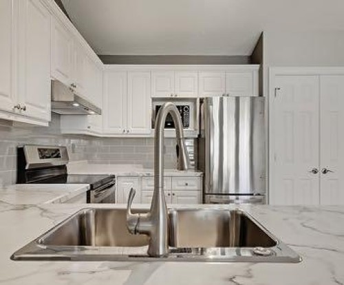 503 Marshall Rise Nw, High River, AB - Indoor Photo Showing Kitchen With Double Sink