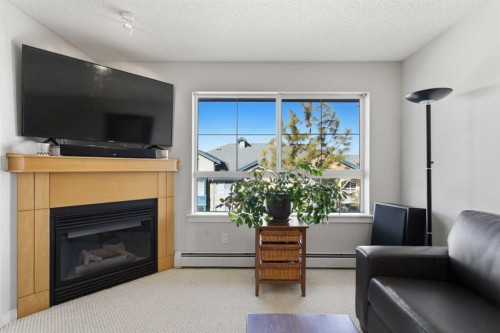 430-22 Richard Place Sw, Calgary, AB - Indoor Photo Showing Living Room With Fireplace