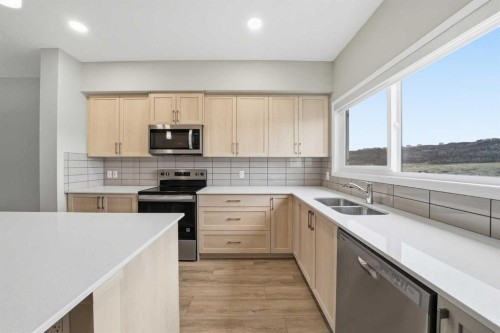 831 Wolf Willow Boulevard Se, Calgary, AB - Indoor Photo Showing Kitchen With Double Sink