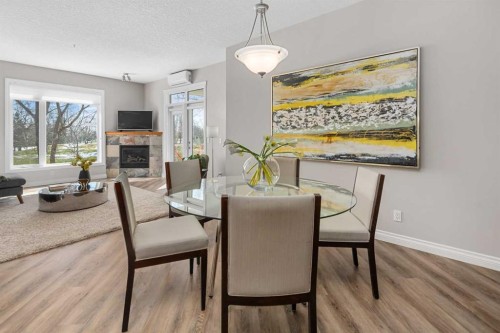 7204-14 Hemlock Crescent Sw, Calgary, AB - Indoor Photo Showing Dining Room With Fireplace