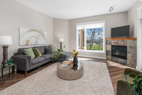 7204-14 Hemlock Crescent Sw, Calgary, AB - Indoor Photo Showing Living Room With Fireplace