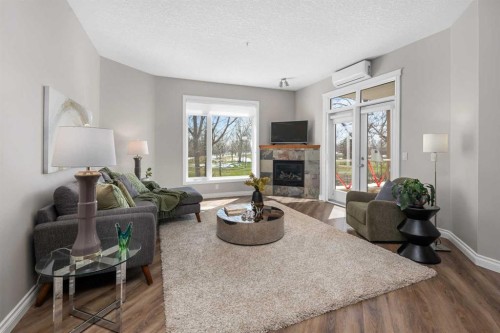 7204-14 Hemlock Crescent Sw, Calgary, AB - Indoor Photo Showing Living Room With Fireplace