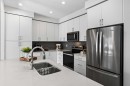 48 Willow Green Sw, Airdrie, AB  - Indoor Photo Showing Kitchen With Double Sink With Upgraded Kitchen 