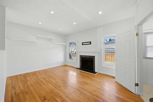 92 Whitlock Close Ne, Calgary, AB - Indoor Photo Showing Other Room With Fireplace