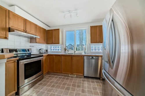 68 Tuscany Springs Way Nw, Calgary, AB - Indoor Photo Showing Kitchen With Stainless Steel Kitchen With Double Sink