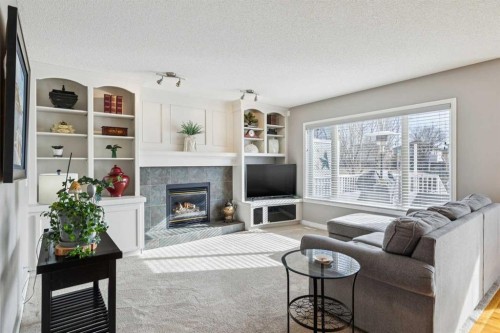 420 Rocky Ridge Bay Nw, Calgary, AB - Indoor Photo Showing Living Room With Fireplace