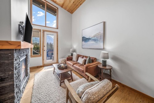 405-1408 Spring Creek Gate, Canmore, AB - Indoor Photo Showing Living Room With Fireplace