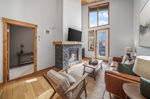 405-1408 Spring Creek Gate, Canmore, AB - Indoor Photo Showing Living Room With Fireplace