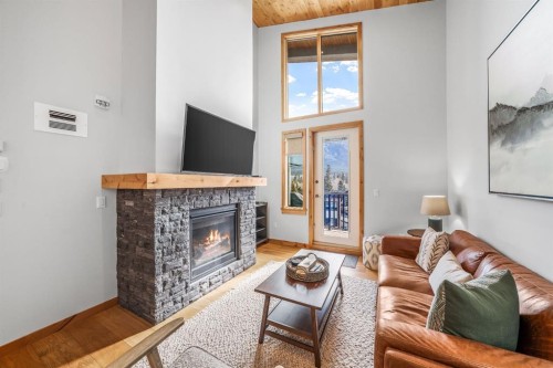 405-1408 Spring Creek Gate, Canmore, AB - Indoor Photo Showing Living Room With Fireplace