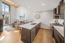 405-1408 Spring Creek Gate, Canmore, AB  - Indoor Photo Showing Kitchen With Fireplace With Double Sink With Upgraded Kitchen 