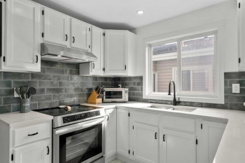 107 Cedargrove Way Sw, Calgary, AB - Indoor Photo Showing Kitchen With Double Sink