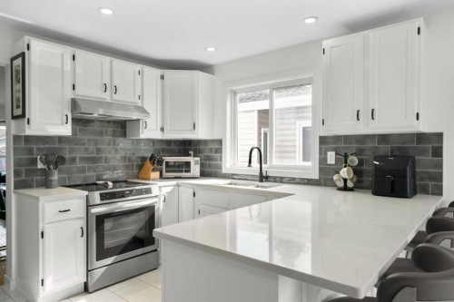 107 Cedargrove Way Sw, Calgary, AB - Indoor Photo Showing Kitchen With Upgraded Kitchen