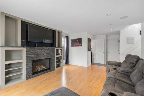 107 Cedargrove Way Sw, Calgary, AB - Indoor Photo Showing Living Room With Fireplace