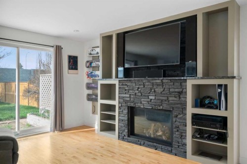 107 Cedargrove Way Sw, Calgary, AB - Indoor Photo Showing Living Room With Fireplace