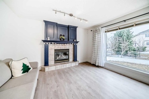 202 Hamptons Gardens Nw, Calgary, AB - Indoor Photo Showing Dining Room With Fireplace