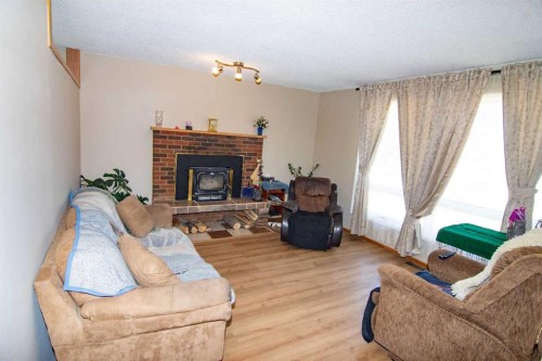 640 Mcculloch Crescent, Irricana, AB - Indoor Photo Showing Living Room With Fireplace