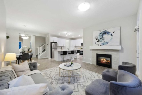 567 Osborne Drive Sw, Airdrie, AB - Indoor Photo Showing Living Room With Fireplace
