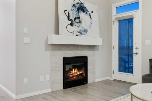 567 Osborne Drive Sw, Airdrie, AB - Indoor Photo Showing Living Room With Fireplace