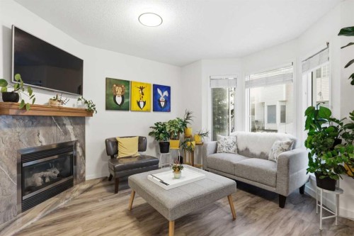 310 Hawkstone Manor Nw, Calgary, AB - Indoor Photo Showing Living Room With Fireplace
