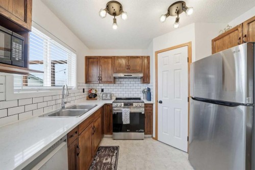 68 Bridleridge Gardens Sw, Calgary, AB - Indoor Photo Showing Kitchen With Stainless Steel Kitchen With Double Sink