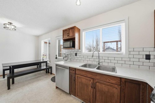 68 Bridleridge Gardens Sw, Calgary, AB - Indoor Photo Showing Kitchen With Double Sink