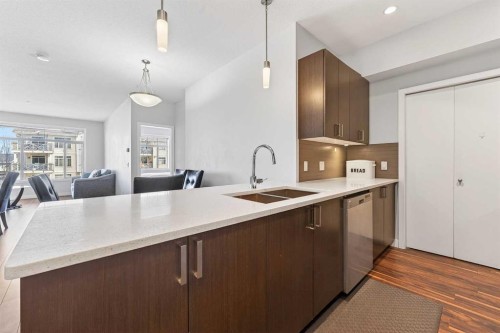 301-16 Auburn Bay Link Se, Calgary, AB - Indoor Photo Showing Kitchen With Double Sink