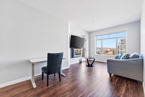 301-16 Auburn Bay Link Se, Calgary, AB - Indoor Photo Showing Living Room With Fireplace
