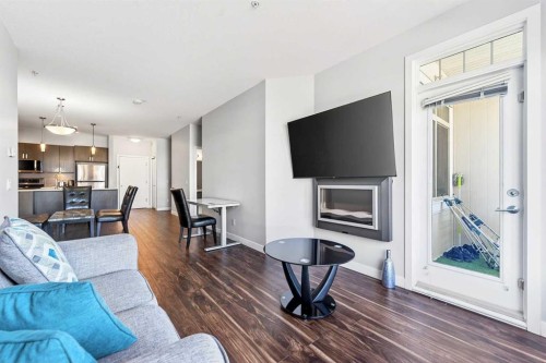 301-16 Auburn Bay Link Se, Calgary, AB - Indoor Photo Showing Living Room With Fireplace