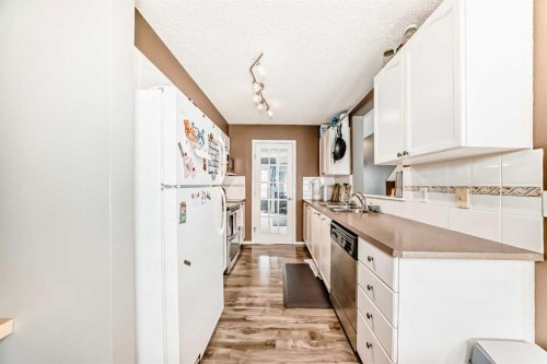 112 Country Village Cape Ne, Calgary, AB - Indoor Photo Showing Kitchen With Double Sink