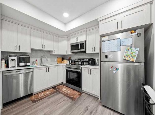 136 Lucas Street Nw, Calgary, AB - Indoor Photo Showing Kitchen With Stainless Steel Kitchen