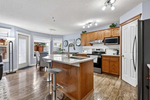129 Bridlewood Way Sw, Calgary, AB - Indoor Photo Showing Kitchen With Stainless Steel Kitchen With Double Sink With Upgraded Kitchen