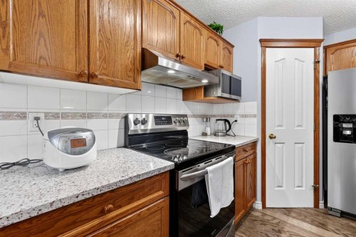 129 Bridlewood Way Sw, Calgary, AB - Indoor Photo Showing Kitchen With Stainless Steel Kitchen