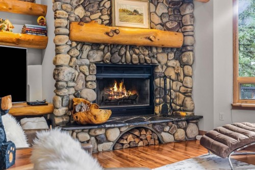 109 Silvertip Ridge, Canmore, AB - Indoor Photo Showing Living Room With Fireplace